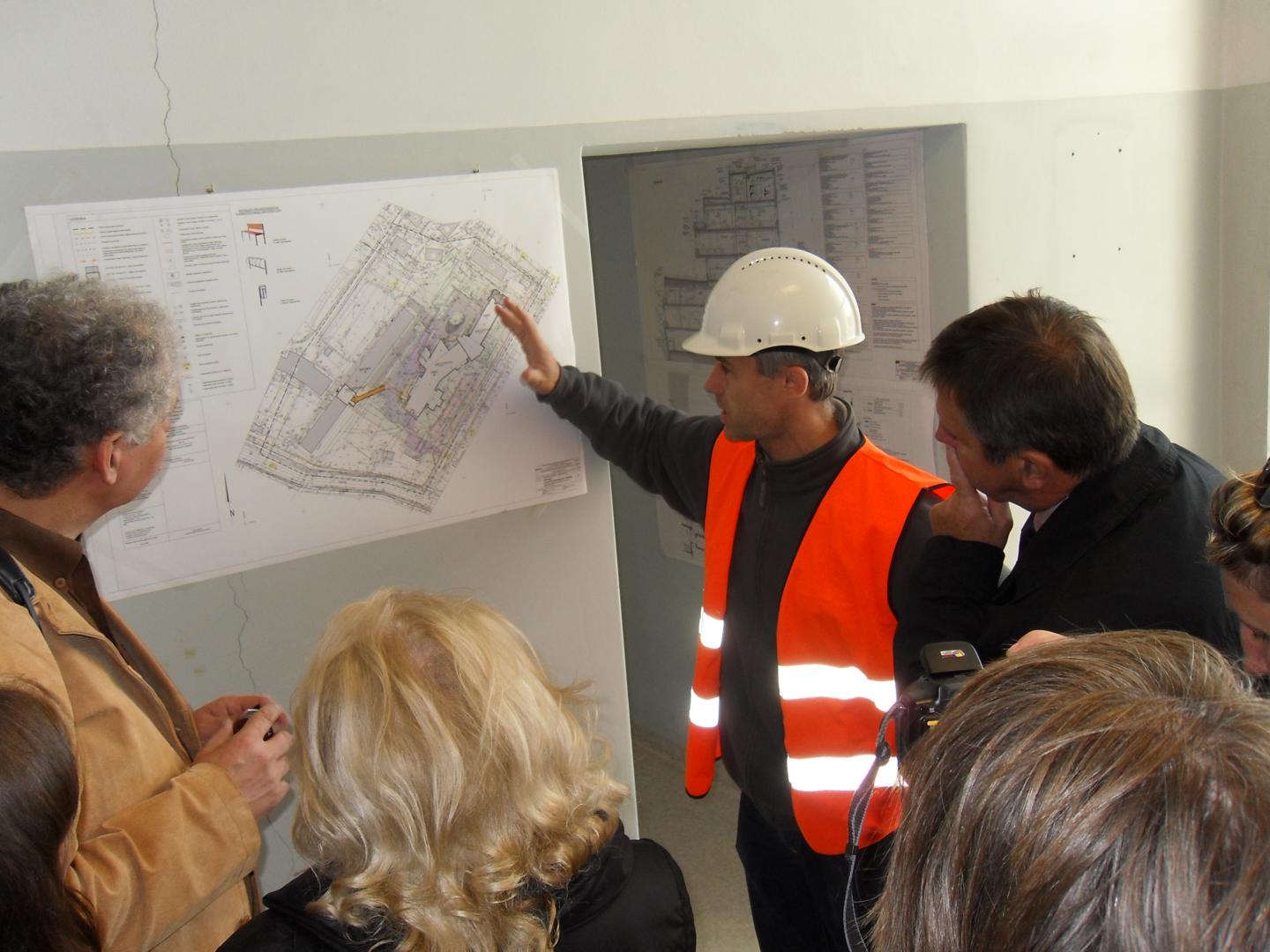 Kierownik budowy centrum zabiegowego w szpitalu przy ul. Arkońskiej przedstawia marszałkowi Markowi Hokowi kolejne etapy inwestycji