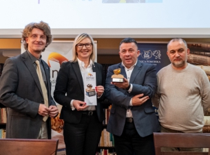 wiceprzewodniczący jury, wicemarszałkini, dyrektor książnicy , dyrektor festiwalu czytania stoją i trzymają w ręce statuetkę oraz ulotkę "Jantar"